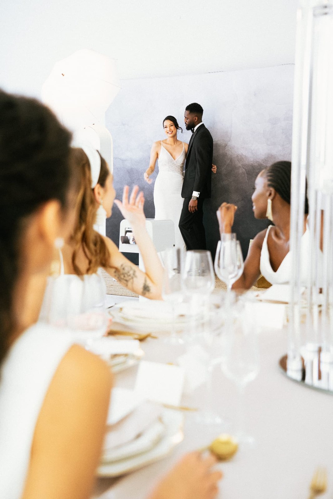 Newlyweds laughing while holding a photo strip